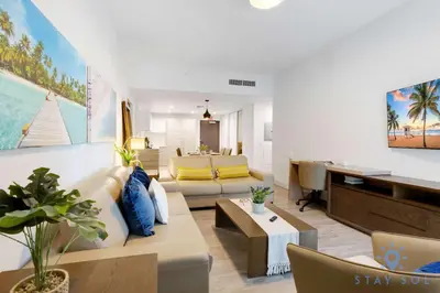 a living room with a couch and a desk at 2BR Apartment with Rooftop Pool in Hollywood