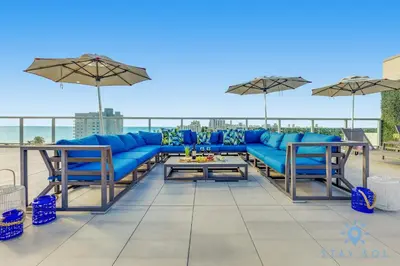 a blue couch sitting on top of a patio at 2BR Apartment with Rooftop Pool in Hollywood