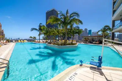 a large swimming pool with palm trees and buildings at Stunning 2 Bed 2 Bath w balcony & incredible views in Miami