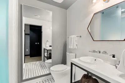 a white bathroom with a toilet and a sink at The Daydrift in Miami Beach