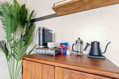 a wooden cabinet with a coffee maker on top of it at The Daydrift in Miami Beach