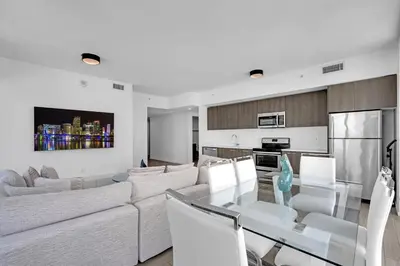 a living room with a white couch and a table at Luxury Downtown Miami Apartment in Miami