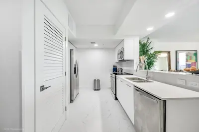 a kitchen with white walls and a white floor at Lux 3BR City-View Retreat in Hollywood, 5th Floor in Hollywood