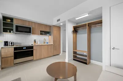 a kitchen with wooden cabinets and a wooden table at Ultimate Elegance Studio with Panoramic City Views in Miami