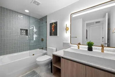 a bathroom with a toilet and a tub and a sink at Ultimate Elegance Studio with Panoramic City Views in Miami