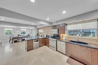 a large kitchen with stainless steel appliances and a dining room at Ft Lauderdale Casa de Las Olas in Fort Lauderdale