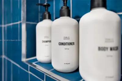 a group of four white bottles sitting on a rack at 2 bedroom Condo at Gale Downtown Pool Gym SPA in Miami