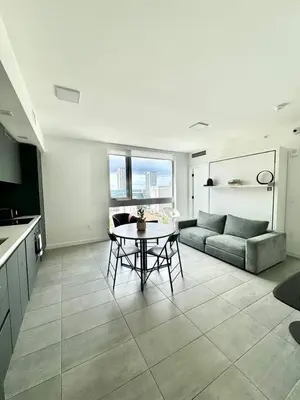 a living room with a table and a couch at 2 bedrooms Design Condo Downtown Miami Pool and Gym in Miami