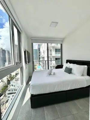 a bedroom with a large bed and a large window at 2 bedrooms Design Condo Downtown Miami Pool and Gym in Miami