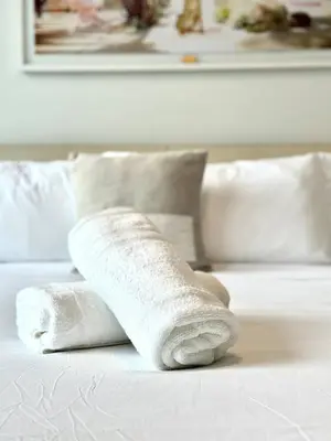 a pair of rolled up towels on a bed at 2 bedrooms Design Condo Downtown Miami Pool and Gym in Miami