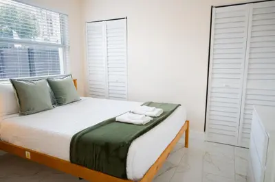 a bedroom with a bed with towels on it at Central Getaway in Little Havana Near Airport, Wynwood, Calle 8 Brickell, Coral Gables and more , Fenced parking in Miami