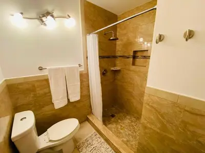 a bathroom with a toilet and a shower at Central Getaway in Little Havana Near Airport, Wynwood, Calle 8 Brickell, Coral Gables and more , Fenced parking in Miami