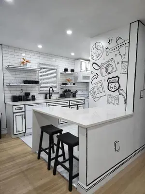 a kitchen with a counter with drawings on the wall at Most Unique Space in Fort Lauderdale