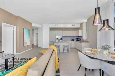 a living room and kitchen with a couch and a table at Luxury Penthouse -Awesome Views-Pools - Free Parking in Hollywood
