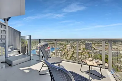 a balcony with chairs and a table on a building at Luxury Penthouse -Awesome Views-Pools - Free Parking in Hollywood