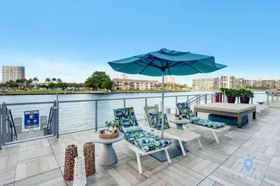 a patio with a table and chairs and an umbrella at Luxury Penthouse -Awesome Views-Pools - Free Parking in Hollywood