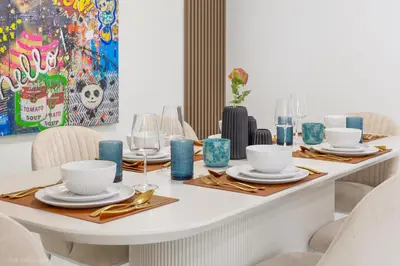 a white table with plates and glasses on it at Lux 3BR City-View Retreat in Hollywood, 4th Floor in Hollywood