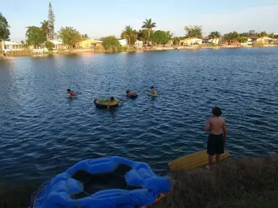 a group of people swimming in a lake at Beach Lake Paradise - Super Location! in Fort Lauderdale