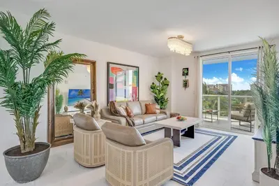 a living room with a couch and chairs and palm trees at Lux 3BR City-View Retreat in Hollywood, 3rd Floor in Hollywood