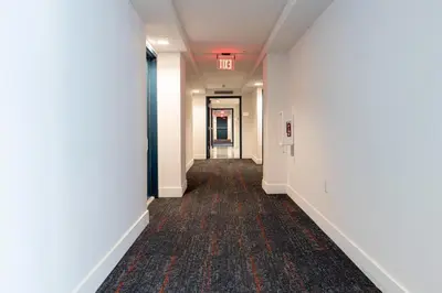 an empty hallway in a building with white walls and a long corridor at Lux 3BR City-View Retreat in Hollywood, 3rd Floor in Hollywood