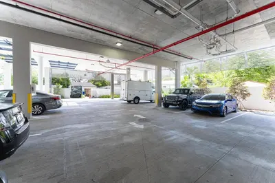 a garage with several cars parked in it at Lux 3BR City-View Retreat in Hollywood, 3rd Floor in Hollywood