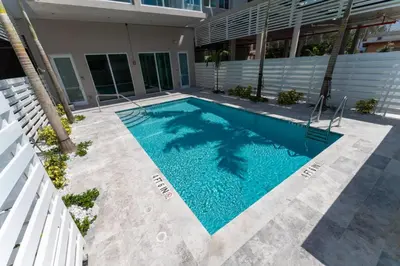 a swimming pool in front of a building at Lux 3BR City-View Retreat in Hollywood, 3rd Floor in Hollywood
