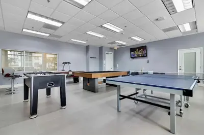 an empty room with two ping pong tables in it at Marvelous Studio in Brickell Free Parking in Miami
