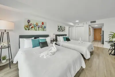two beds in a room with white and blue at Marvelous Studio in Brickell Free Parking in Miami