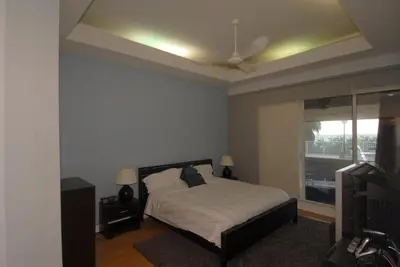 a bedroom with a bed and a ceiling fan at Luxury Ocean Front Condo on Millionaires Row in Miami Beach