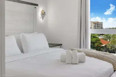 a white bed with white pillows and a window at Lux 3BR City-View Retreat in Hollywood, 2nd Floor in Hollywood
