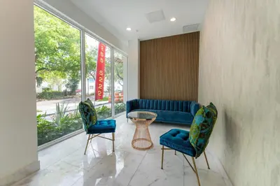 a lobby with two blue chairs and a table at Lux 3BR City-View Retreat in Hollywood, 2nd Floor in Hollywood
