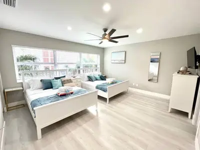 a living room with a white couch and a ceiling fan at 1 Block from the Beach 2BR 2BA Newly Renovated in Fort Lauderdale