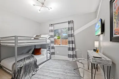 a bedroom with two bunk beds and a desk at Daiquiri in Dania Beach