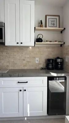 a kitchen with white cabinets and a black oven at Coastal Haven 5 Min to Beach, Patio, BBQ in Dania Beach