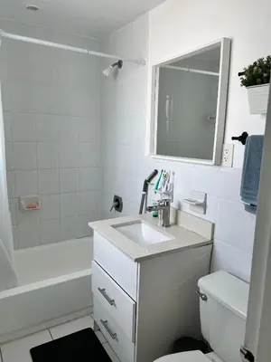 a white bathroom with a sink and a mirror at Casablanca miami beach in Miami Beach
