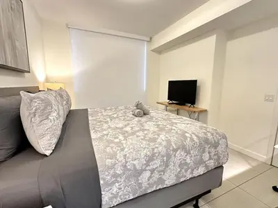 a bedroom with a bed with a teddy bear on it at Doral Studio with Fabulous View in Miami