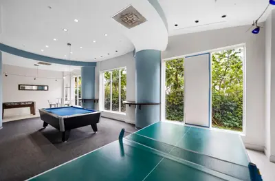 a pool table in a room with a ping pong ball at Oceanfront Luxury Condo with Stunning Views and Resort Amenities in Hollywood