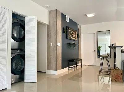 a living room with two washer and dryer at Modern Home w Jacuzzi Near Wynwood-Design District-MIA Airport in Miami