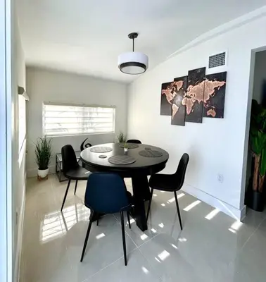 a dining room with a table and chairs at Modern Home w Jacuzzi Near Wynwood-Design District-MIA Airport in Miami