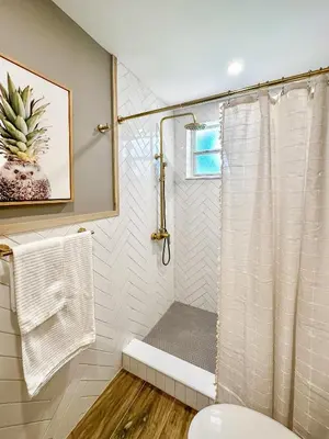 a bathroom with a shower with a shower curtain at Imagine Residence in Hallandale Beach