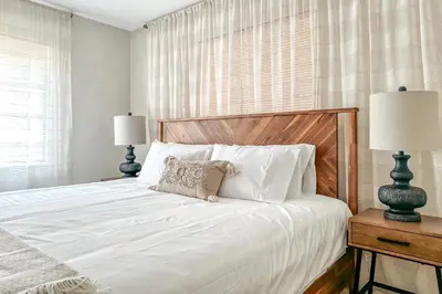 a bedroom with a large white bed with two lamps at Imagine Residence in Hallandale Beach