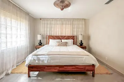 a bedroom with a large bed and two night stands at Imagine Residence in Hallandale Beach
