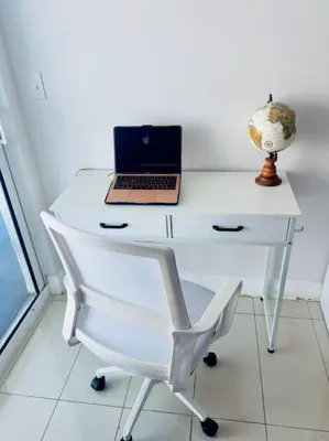 a white desk with a laptop and a chair at 36th-Floor Ocean View Brickell - Free Parking in Miami