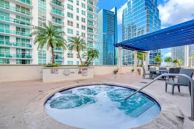 a hot tub in the middle of a patio with buildings at 36th-Floor Ocean View Brickell - Free Parking in Miami