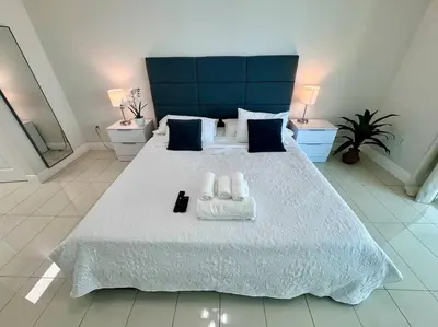 a bedroom with a large white bed with two towels at 36th-Floor Ocean View Brickell - Free Parking in Miami