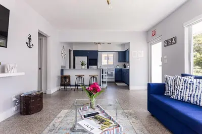 a living room with a blue couch and a table at Beach Oasis King Bed & Near Hollywood beach in Hollywood