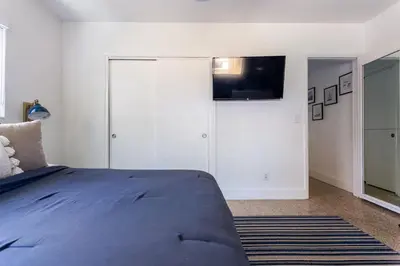 a bedroom with a bed and a flat screen tv at Beach Oasis King Bed & Near Hollywood beach in Hollywood