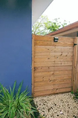 a wooden gate on the side of a house at Beach Oasis King Bed & Near Hollywood beach in Hollywood