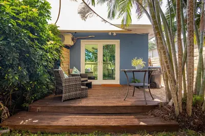 a wooden deck with a table and chairs on a house at Peaceful Casita near Hollywood Beach & essentials in Hollywood