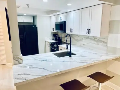 a kitchen with a marble counter top and a sink at OCEAN VIEW 1BR 2BA BEACH CONDO Parking in Miami Beach